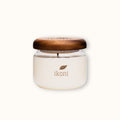 Glass jar with wooden lid that is ikoni Premium Candle.